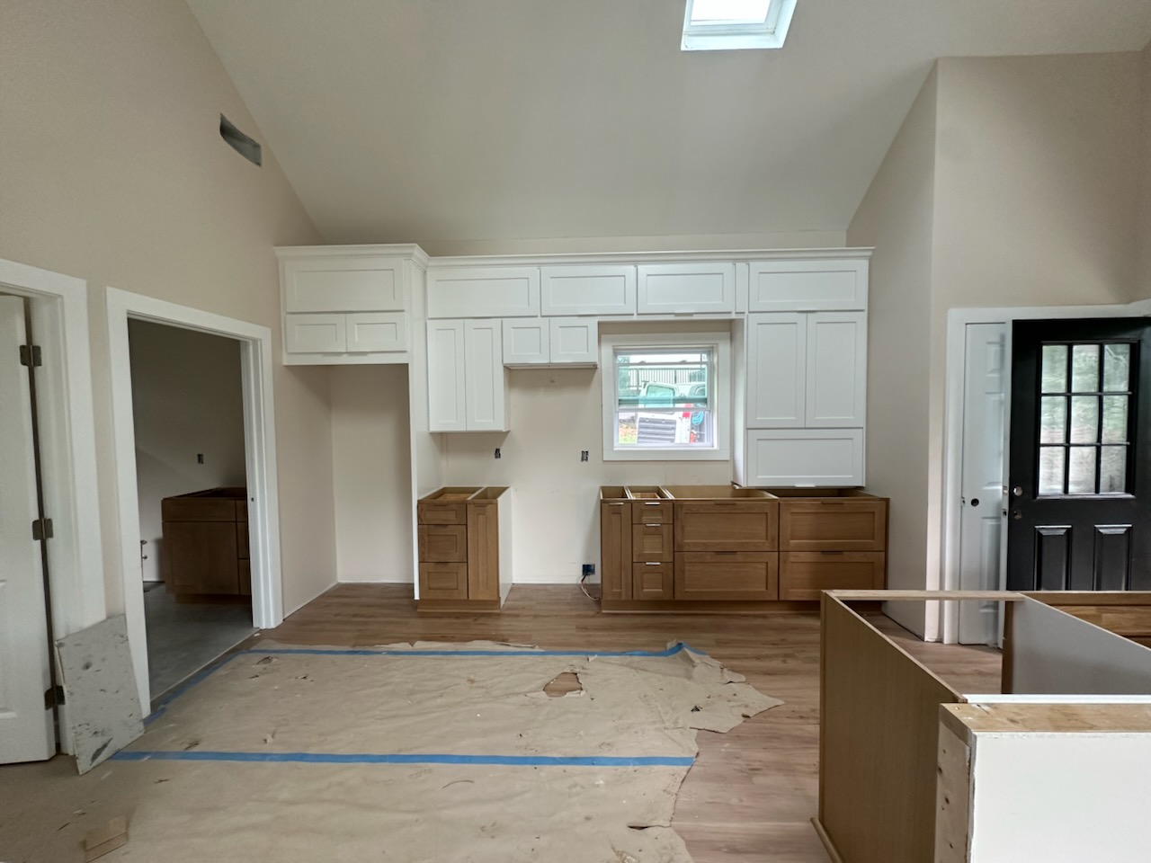 White upper cabinets and natural stained base cabinets in a vaulted Suwanee, GA kitchen