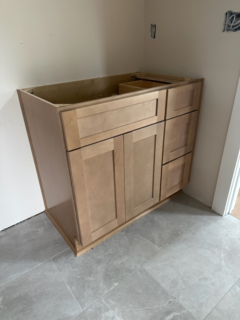 Natural maple shaker vanity base cabinet installed on tile in a Suwanee, GA bathroom